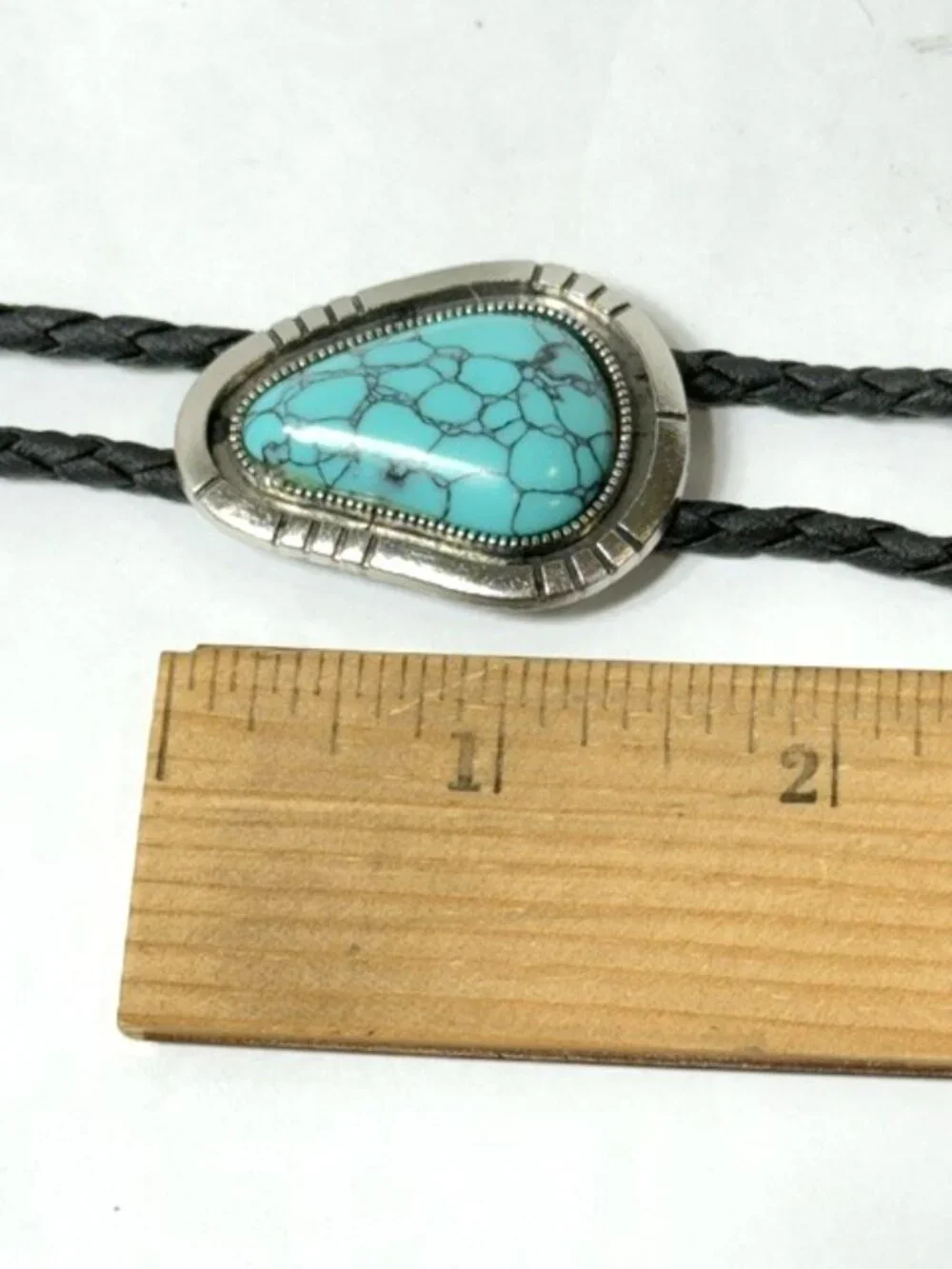 Turquoise-tone stone, black cord western cowboy bolo tie.